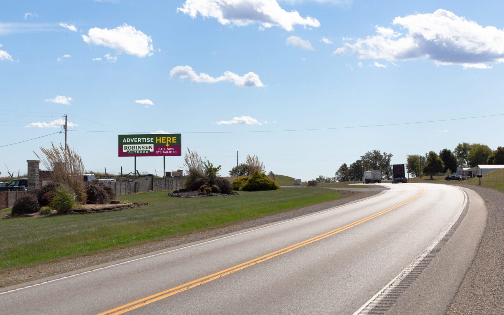 A highway with a billboard on the side of it.