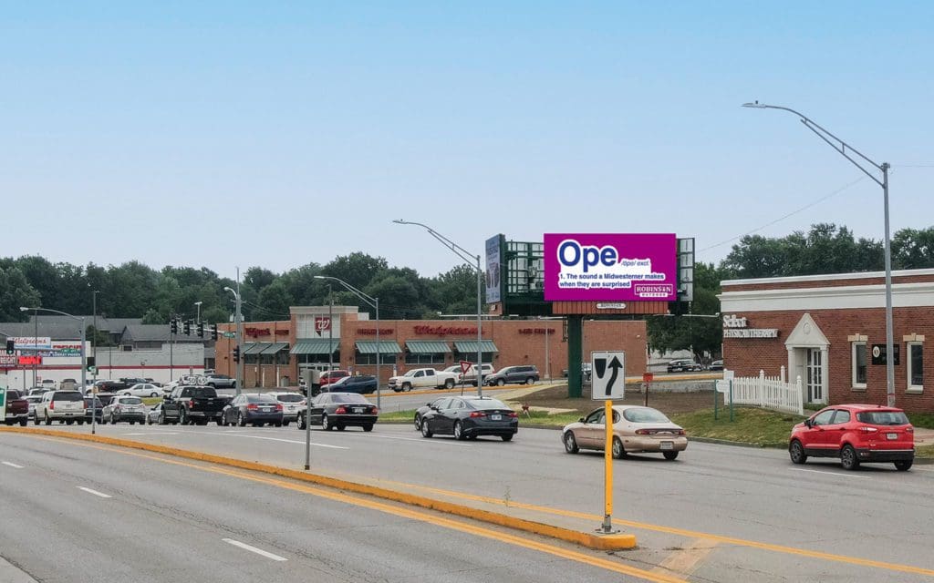 A large billboard on the side of a road.