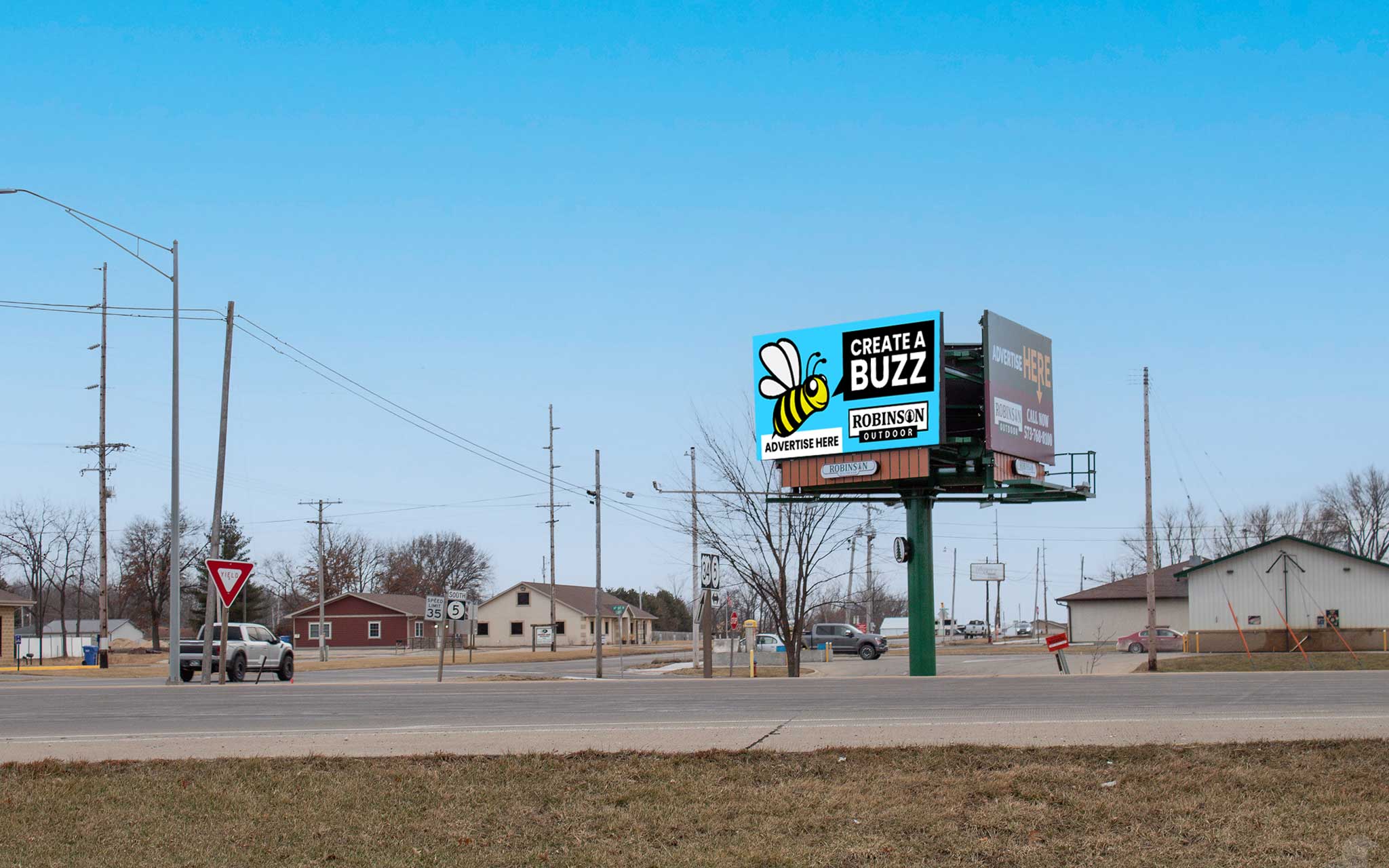 A large billboard sitting on top of an empty road.