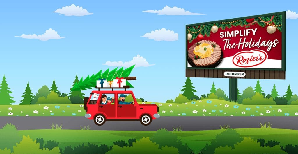 A red car driving down the road with a tree on top of it.
