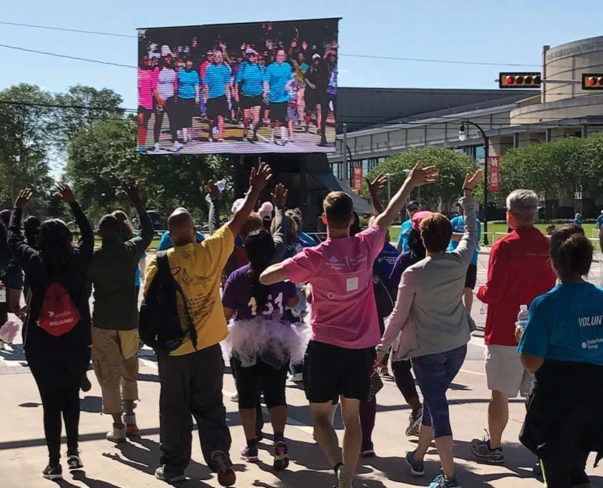 A group of people walking down the street