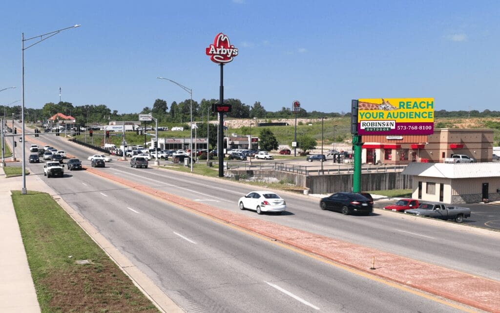 A highway with cars driving on it and a stop sign.