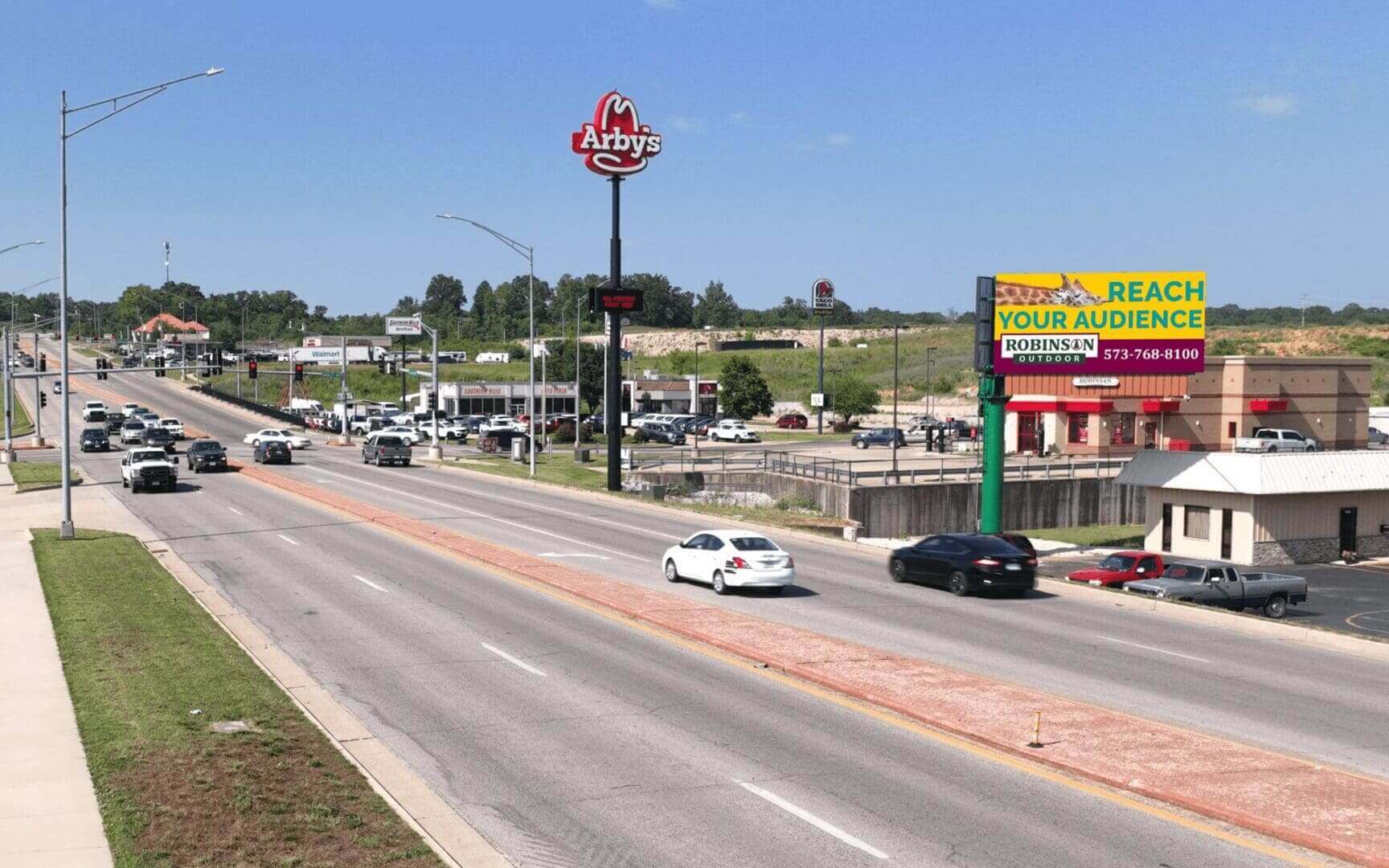 A highway with cars driving on it and a stop sign.