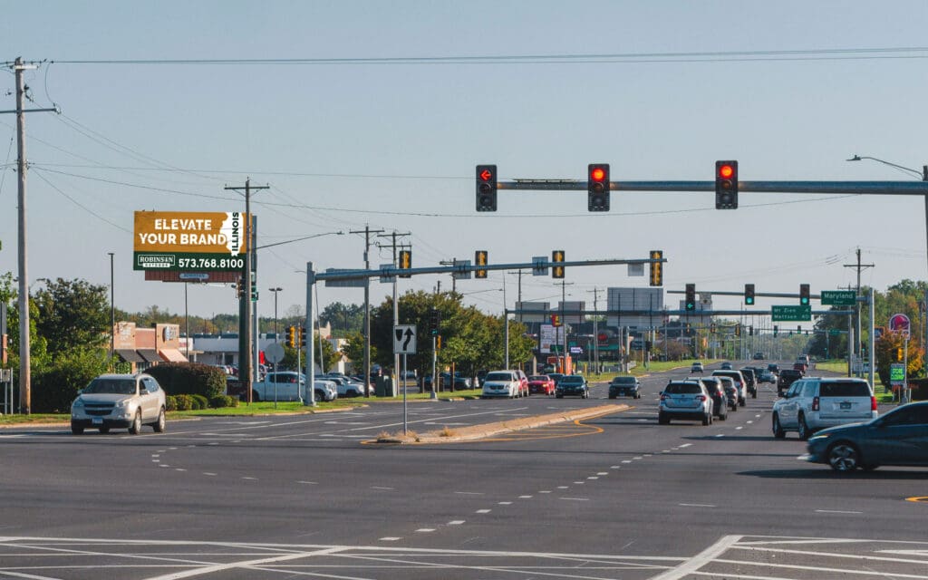 A street with cars and traffic lights on it.