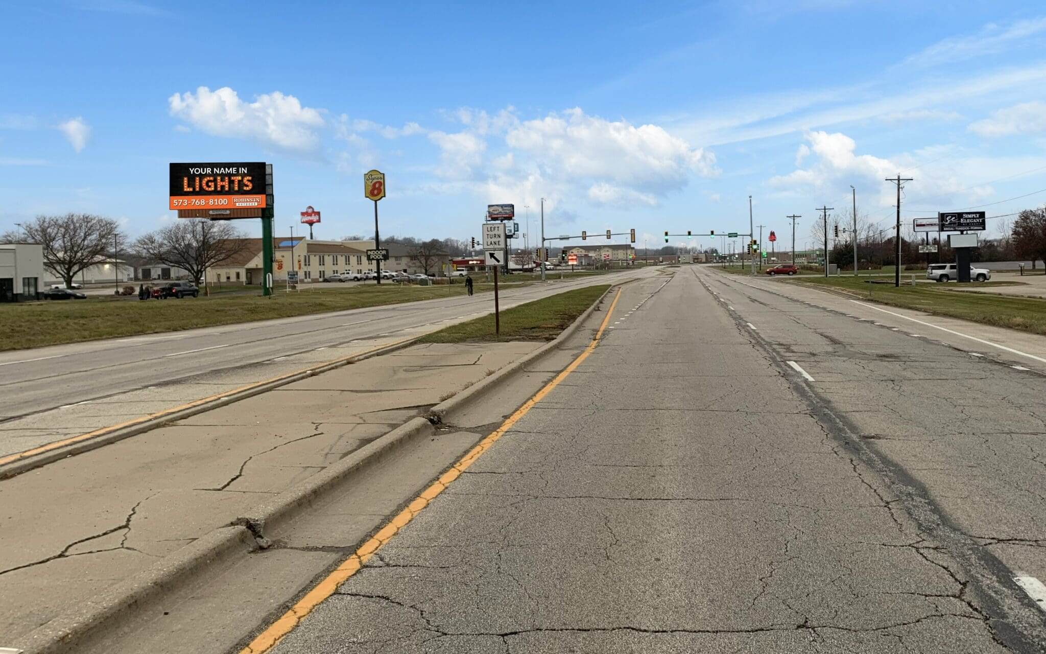 A road with no traffic on it and signs