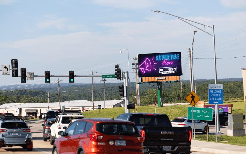 A busy highway with cars and traffic lights.