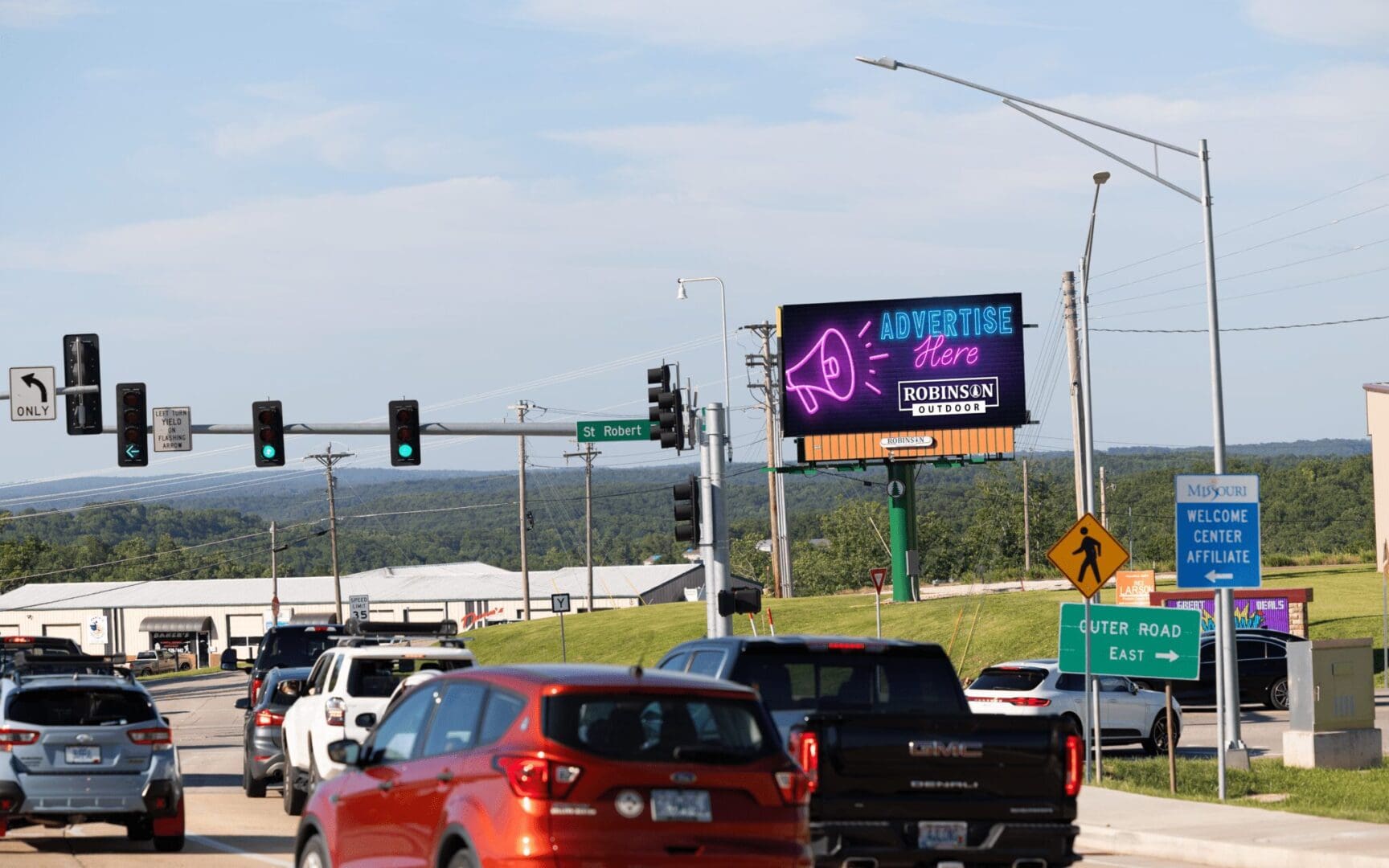 A busy highway with cars and traffic lights.