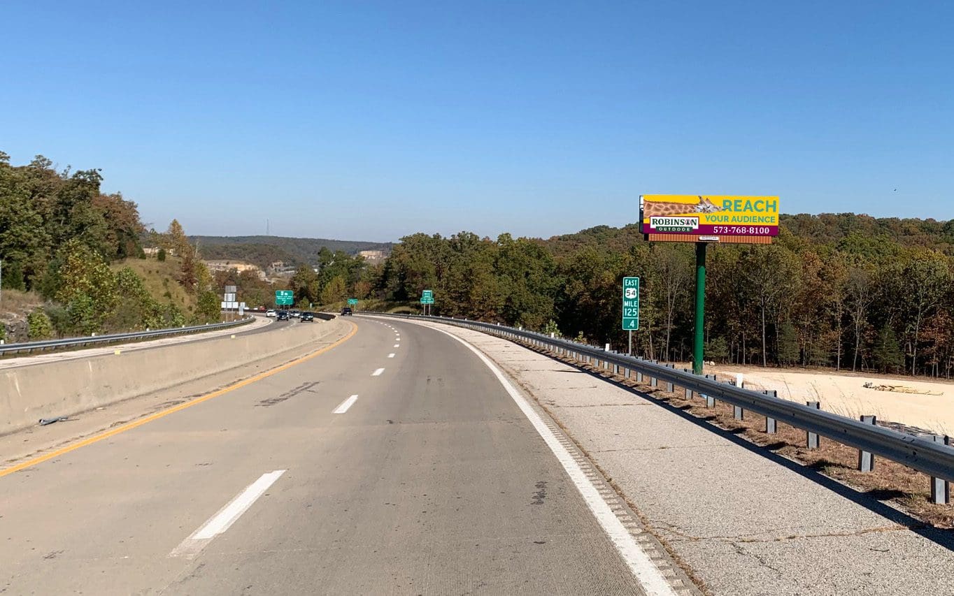 A highway with many signs on the side of it.