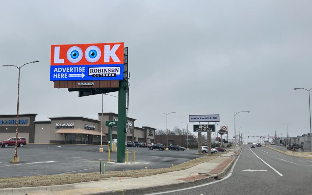 A large billboard on the side of a road.