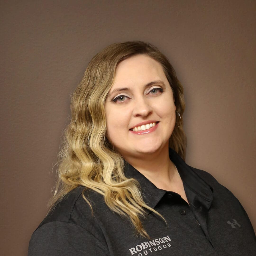A woman in black shirt smiling for the camera.