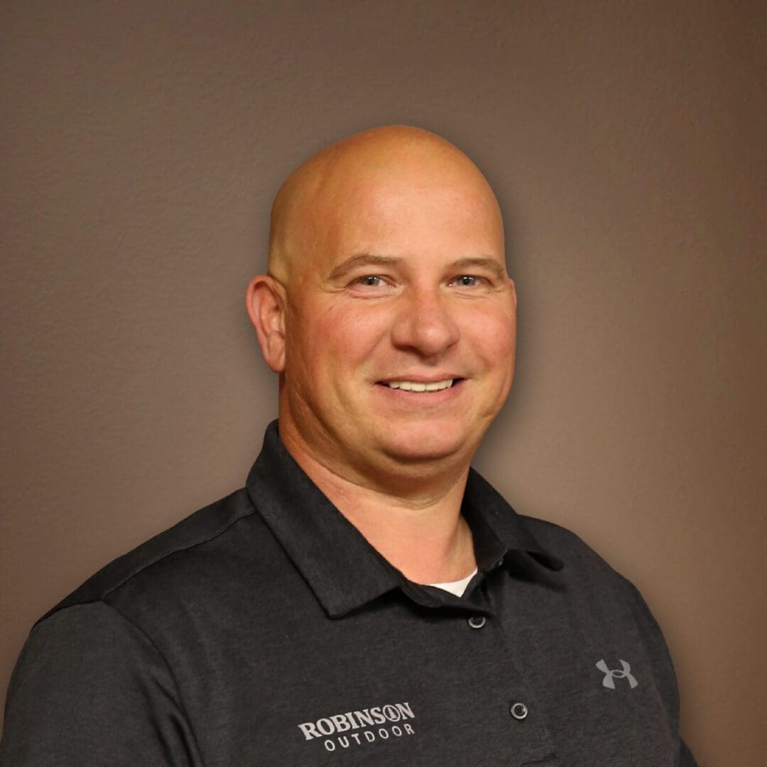 A man with bald head wearing black shirt.