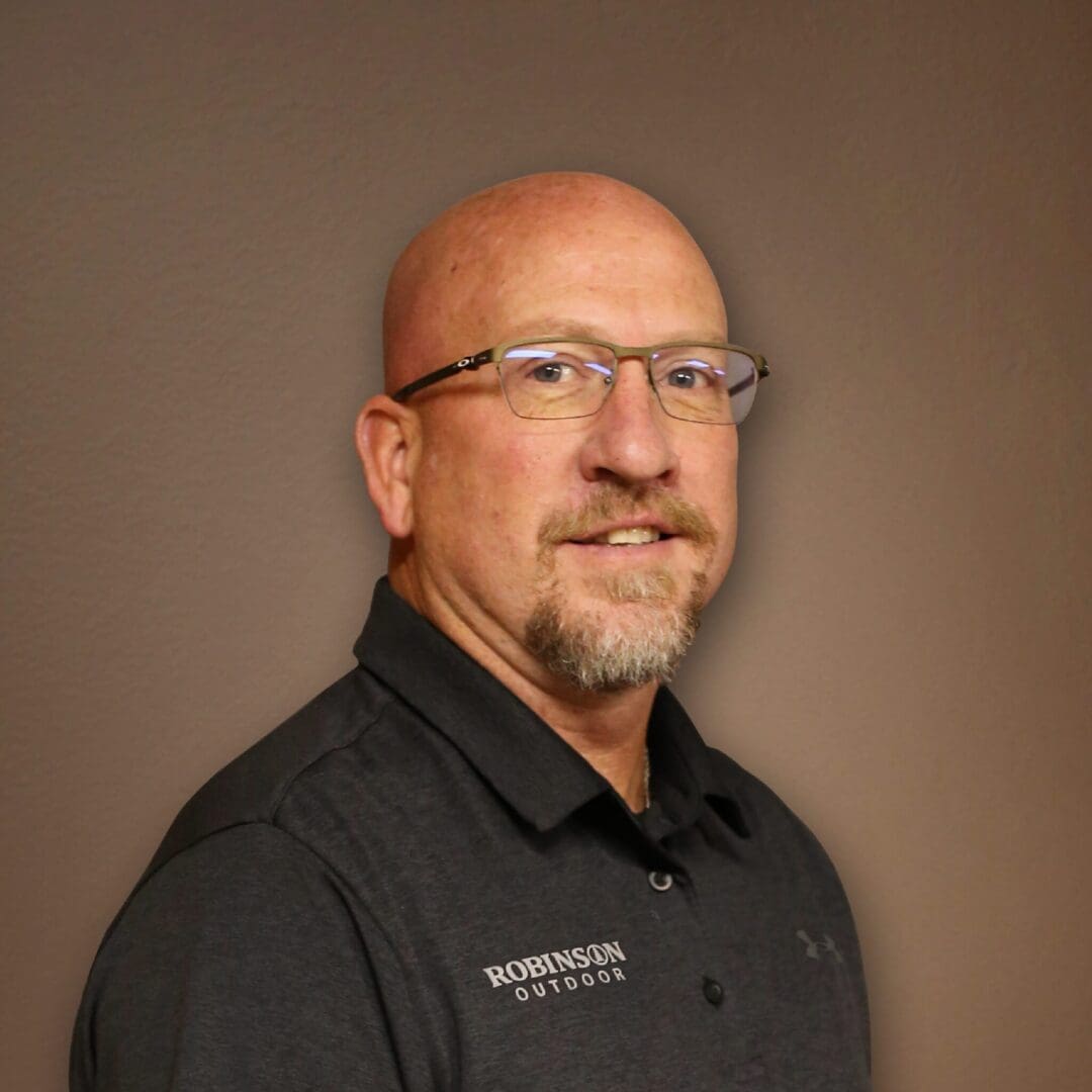 A man with glasses and a beard wearing black.