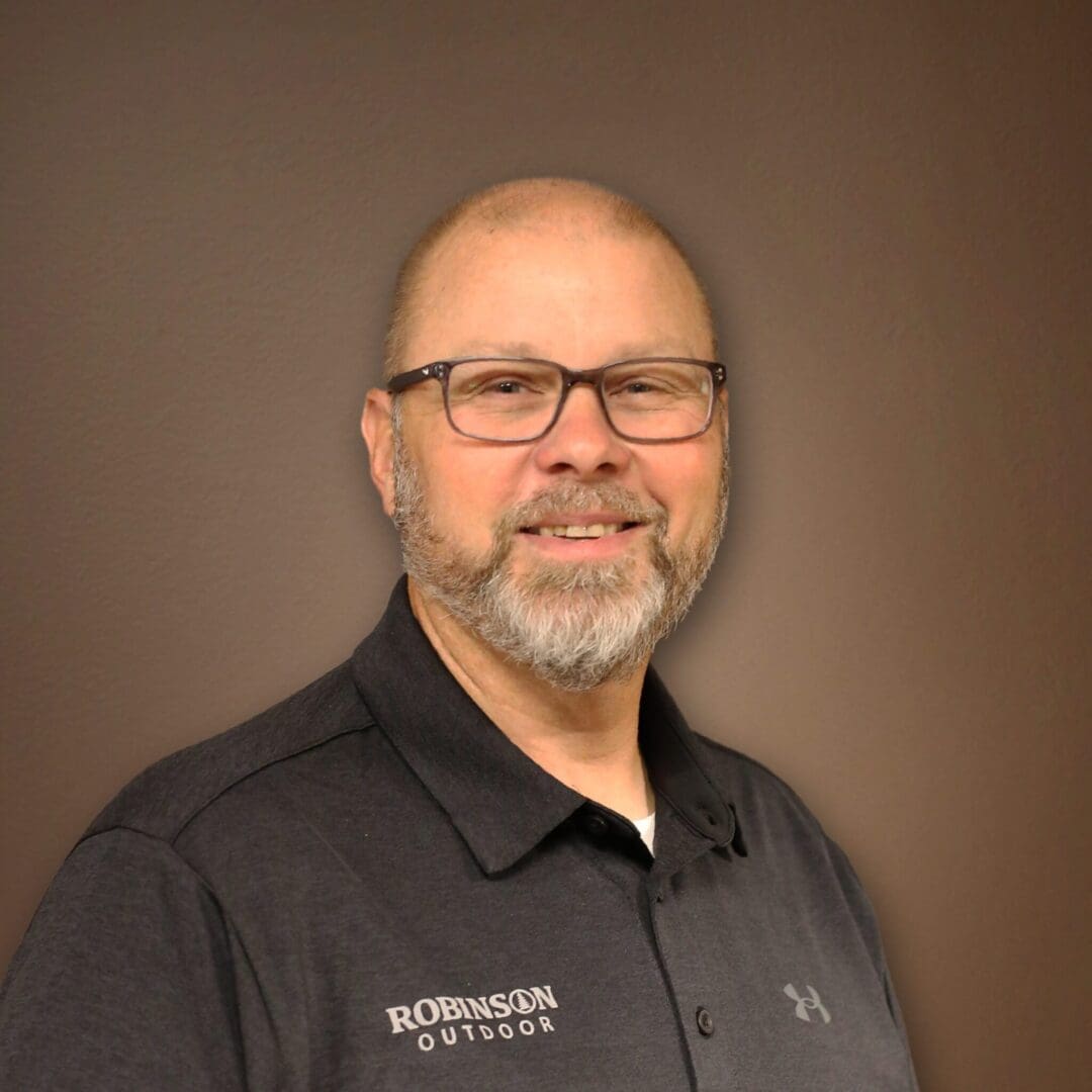 A man with glasses and beard wearing black shirt.