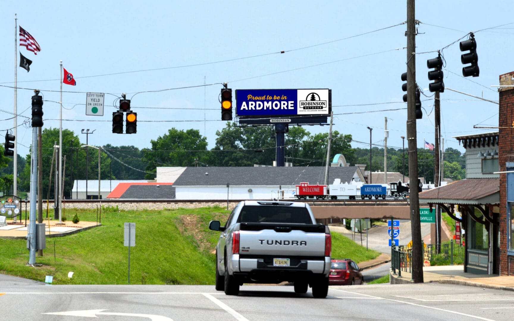Pickup truck at small town intersection under billboard