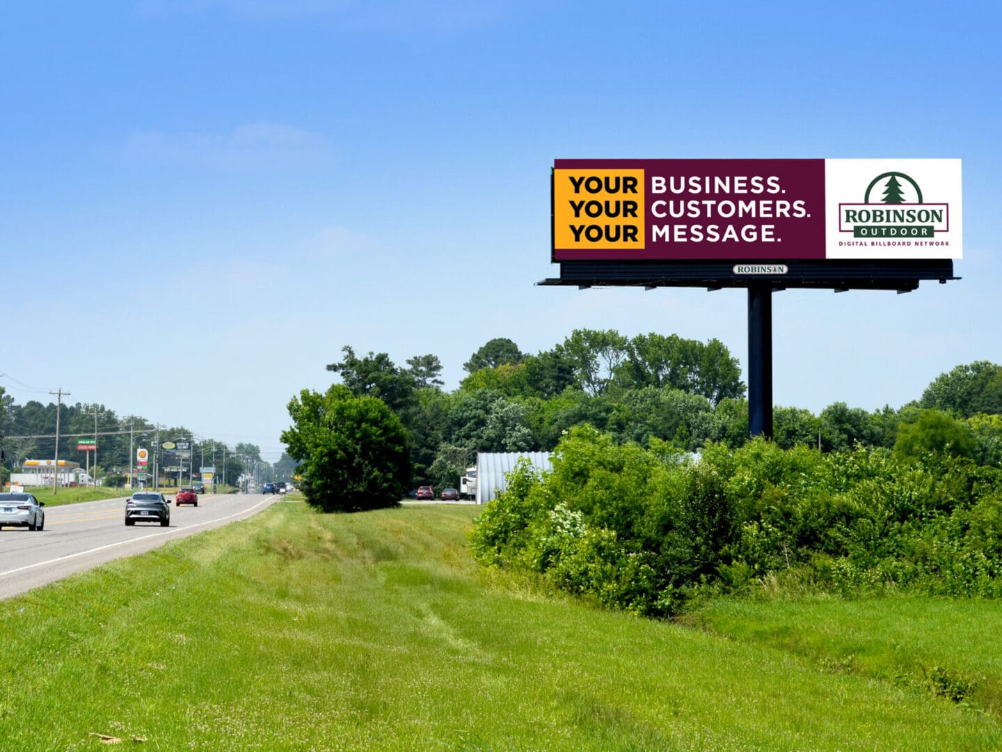 Billboard advertising space beside highway with trees